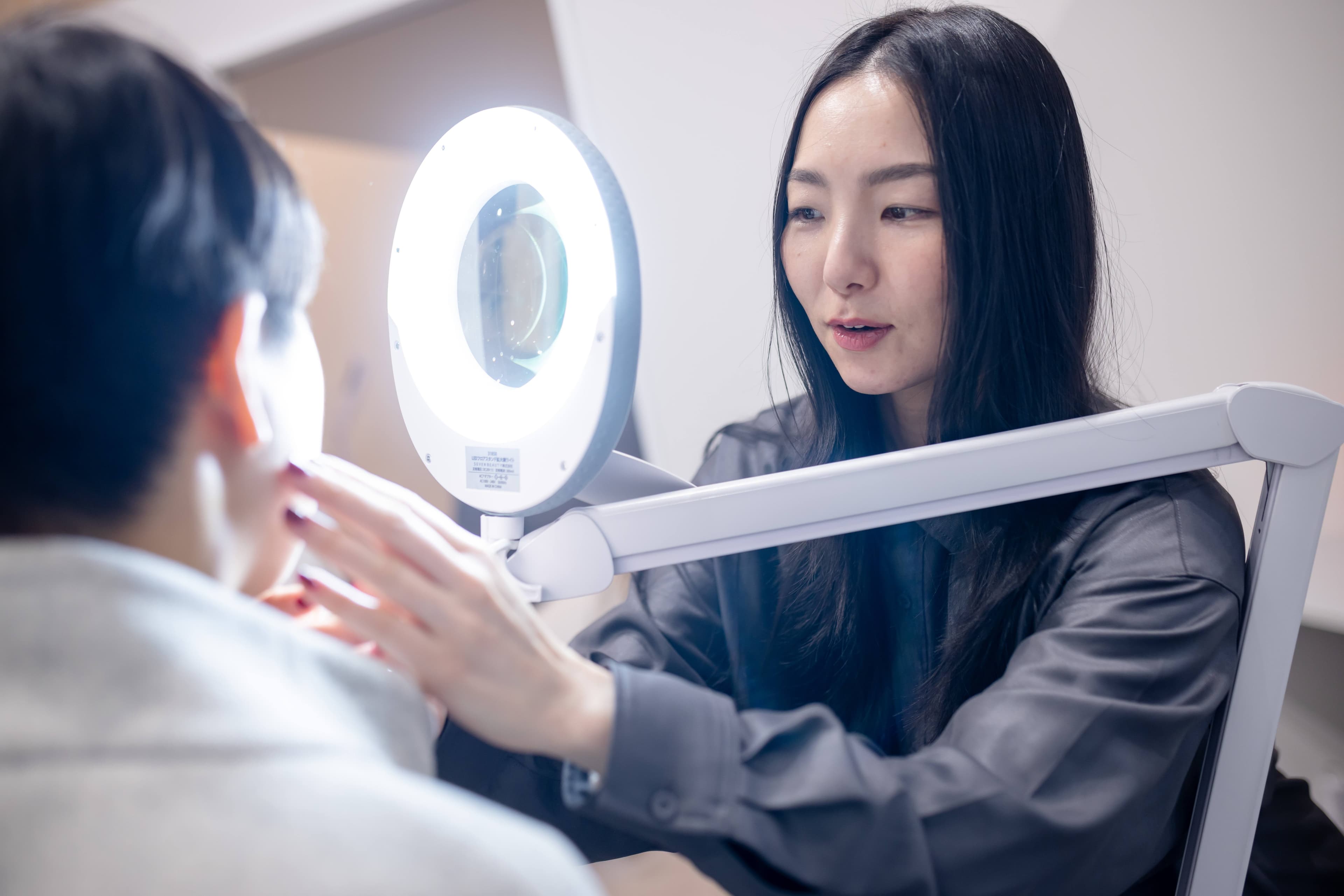 専門機器を使用してお客様の肌の状態を丁寧にチェックしている様子